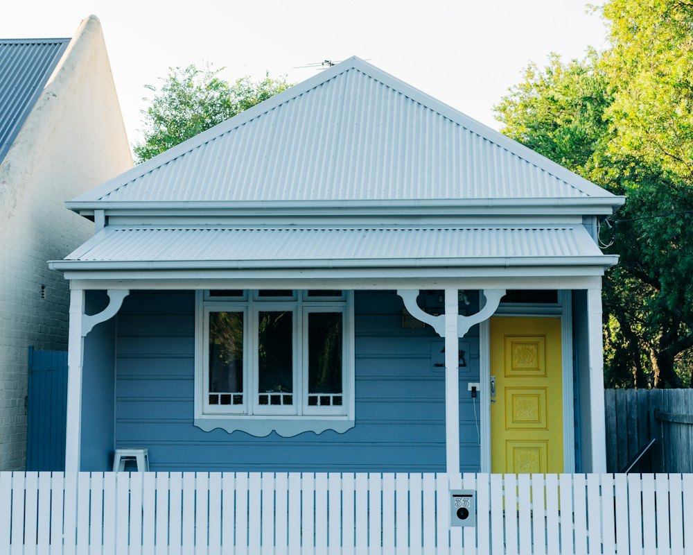 A weatherboard home with a picket fence (stock photo)